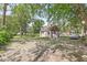 Backyard shed is nestled among mature trees, next to parking for an automobile at 6110 Orinoco Ave, Indianapolis, IN 46227