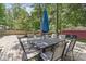 This backyard features a large wooden deck and dining table with chairs and a fire pit at 6110 Orinoco Ave, Indianapolis, IN 46227