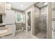 Bright bathroom featuring a tiled shower with glass door, plus washer and dryer at 6110 Orinoco Ave, Indianapolis, IN 46227