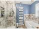 Spa bathroom boasting a glass shower, standalone tub, and unique patterned tile at 6110 Orinoco Ave, Indianapolis, IN 46227