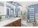 Stylish bathroom featuring a wooden vanity, illuminated mirror, and a modern glass-enclosed shower at 6110 Orinoco Ave, Indianapolis, IN 46227