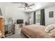Bedroom with a ceiling fan, large window, and neutral decor at 6110 Orinoco Ave, Indianapolis, IN 46227