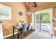 Cozy dining area with natural light, modern light fixture, and a sliding door that leads to the outside at 6110 Orinoco Ave, Indianapolis, IN 46227