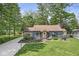 Charming home featuring a well-manicured lawn, beautiful landscaping, and a cozy front porch at 6110 Orinoco Ave, Indianapolis, IN 46227