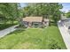 Charming home boasts mature trees and landscaping with a well-manicured lawn at 6110 Orinoco Ave, Indianapolis, IN 46227