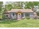 Charming front exterior with lush landscaping, brick accents, and a inviting porch at 6110 Orinoco Ave, Indianapolis, IN 46227