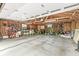This garage features exposed rafters, shelving, and a concrete floor with a crack at 6110 Orinoco Ave, Indianapolis, IN 46227