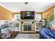 Open-concept living room featuring a stone fireplace, built-in shelving, and hardwood floors at 6110 Orinoco Ave, Indianapolis, IN 46227