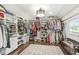 Spacious walk-in closet with custom shelving and ample storage, providing organization for clothing and accessories at 6110 Orinoco Ave, Indianapolis, IN 46227