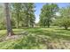 Expansive yard with mature trees offering shade, and a lush green lawn at 6110 Orinoco Ave, Indianapolis, IN 46227