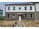 A view of the exterior of the house featuring a brick and white siding and a gray concrete walkway at 6150 Cascades Dr, Whitestown, IN 46075