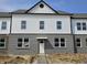 New two-story home featuring a brick and siding exterior with black trim details and a welcoming front door at 6162 Cascades Dr, Whitestown, IN 46075