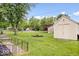 Expansive backyard with shed, mature trees, and a charming fence at 620 Meadows Dr, Mooresville, IN 46158