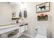 Modern half bath with stylish vanity, patterned floor, and decorative accents at 620 Meadows Dr, Mooresville, IN 46158