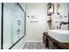 Modern bathroom features a walk-in shower with black trim and a sliding barn door vanity at 620 Meadows Dr, Mooresville, IN 46158