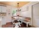 Cozy dining area features custom bench seating, wood floors, and a stylish chandelier at 620 Meadows Dr, Mooresville, IN 46158