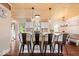 Modern kitchen featuring a central island with bar stools, pendant lighting, and sleek appliances at 620 Meadows Dr, Mooresville, IN 46158