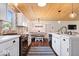 Open kitchen and dining area featuring white cabinets, stainless steel appliances and an island at 620 Meadows Dr, Mooresville, IN 46158