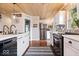 Bright kitchen with stainless steel appliances, white cabinets, and hardwood floors at 620 Meadows Dr, Mooresville, IN 46158