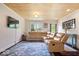 Bright living room featuring a wood-paneled ceiling, hardwood floors, and ample seating at 620 Meadows Dr, Mooresville, IN 46158