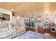 Open-concept living area with wood-paneled ceiling, hardwood floors, and seamless flow to kitchen at 620 Meadows Dr, Mooresville, IN 46158