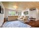 Comfortable living room with wood-paneled ceiling, hardwood floors, and a sectional sofa at 620 Meadows Dr, Mooresville, IN 46158