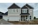 New two-story home featuring a two-car garage and a welcoming front porch at 6421 Springtide Ct, Plainfield, IN 46168