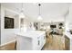 Open-concept kitchen with island, white cabinets, and seamlessly connected living and dining areas at 6421 Springtide Ct, Plainfield, IN 46168
