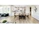 Bright, open-concept kitchen with stainless appliances and a large wooden dining table at 6421 Springtide Ct, Plainfield, IN 46168