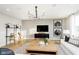 Bright living room features stylish decor, large TV and unique light fixture at 6421 Springtide Ct, Plainfield, IN 46168