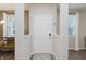 Modern entryway with white door, neutral walls, and view of the nearby living area at 6465 Wasco Dr, Whitestown, IN 46075