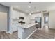 Modern kitchen with stainless appliances, white cabinetry, and quartz countertops at 6465 Wasco Dr, Whitestown, IN 46075