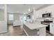 Bright, open kitchen with stainless appliances, quartz counters, and a view of the living room at 6465 Wasco Dr, Whitestown, IN 46075