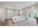 This cozy living room features a plush sofa, wood floors, and sun-filled windows at 6465 Wasco Dr, Whitestown, IN 46075