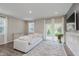Bright living room features a comfortable white sofa, neutral rug, and sliding glass doors at 6465 Wasco Dr, Whitestown, IN 46075