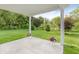 Charming covered patio overlooking a serene backyard, adorned with vibrant flower pots, creating a relaxing outdoor oasis at 6465 Wasco Dr, Whitestown, IN 46075