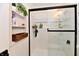 Modern bathroom with a sleek glass-enclosed shower and built-in shelving for storage at 6556 Wandering Way, Indianapolis, IN 46241