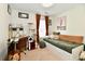 Bright bedroom featuring a desk, daybed with storage, and warm, inviting decor at 6556 Wandering Way, Indianapolis, IN 46241