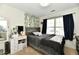 Cozy bedroom with natural light, comfortable bedding, and a vanity area at 6556 Wandering Way, Indianapolis, IN 46241