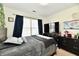 Bedroom with large window, comfy bed, and storage, illuminated by natural light at 6556 Wandering Way, Indianapolis, IN 46241