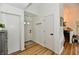 Welcoming entryway with wood floors, white walls, and clear sightlines into adjacent rooms at 6556 Wandering Way, Indianapolis, IN 46241