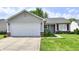 Attractive single-story home with a two-car garage, tidy landscaping, and a welcoming driveway at 6556 Wandering Way, Indianapolis, IN 46241