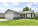Inviting single-story home featuring an attached two-car garage, tidy landscaping, and classic curb appeal at 6556 Wandering Way, Indianapolis, IN 46241