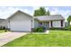 Charming single-story home with a well-maintained lawn, a two-car garage, and inviting curb appeal at 6556 Wandering Way, Indianapolis, IN 46241