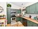 Contemporary kitchen featuring stainless appliances, modern cabinetry, and wood countertops at 6556 Wandering Way, Indianapolis, IN 46241