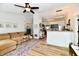 Bright living room featuring a plush couch, elegant area rug, and a ceiling fan at 6556 Wandering Way, Indianapolis, IN 46241