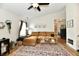 Inviting living room with large comfy couch, stylish rug, and natural light from the window at 6556 Wandering Way, Indianapolis, IN 46241