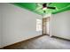 Bedroom featuring green ceiling with white football field design, window and closet at 6715 Wandering Way, Indianapolis, IN 46241