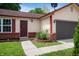 Charming single Gathering home with a red door, one car garage and brick landscaping features at 6715 Wandering Way, Indianapolis, IN 46241
