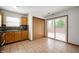 The kitchen has wood cabinets, tile flooring, and sliding glass doors to the backyard at 6715 Wandering Way, Indianapolis, IN 46241